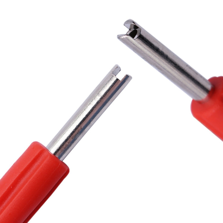 Close-up of red-handled valve core wrench key with chrome prong ends
