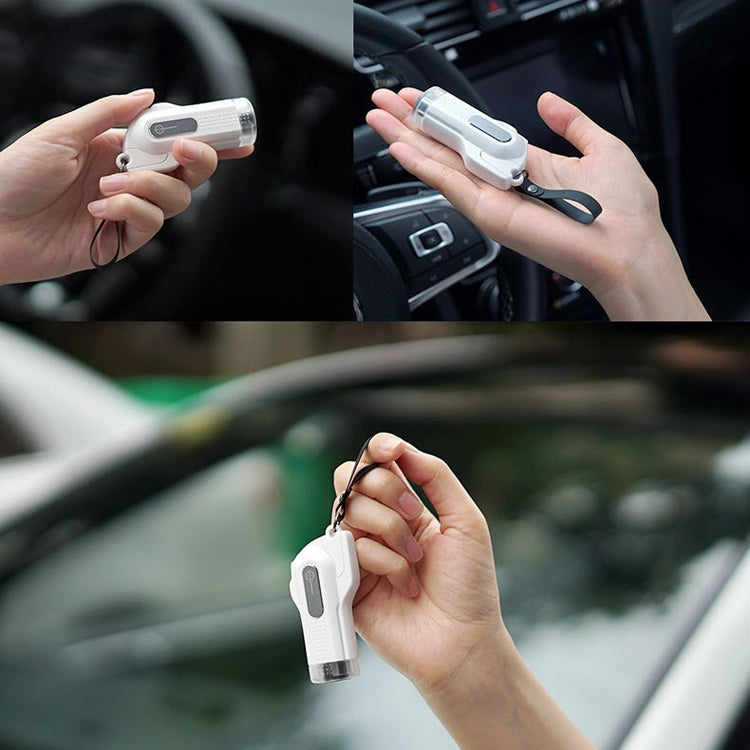 White safety hammer window breaker keychain in hand for emergency use