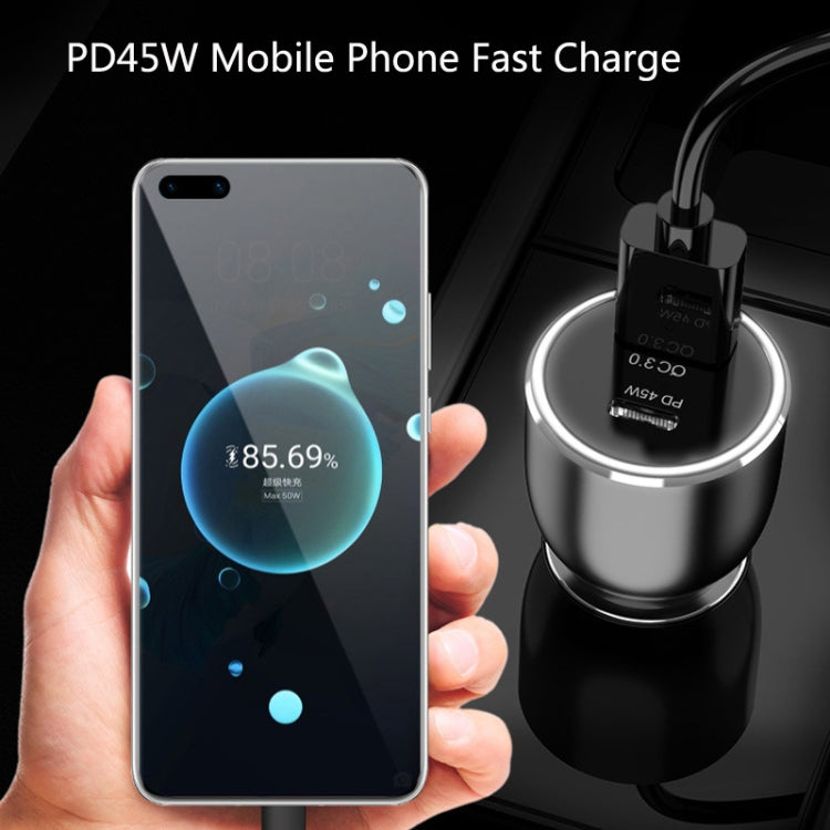 Black car USB-C charger held near smartphone, showing top charging ring light