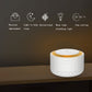 White cylindrical sleep sound machine with warm orange top ring and front controls