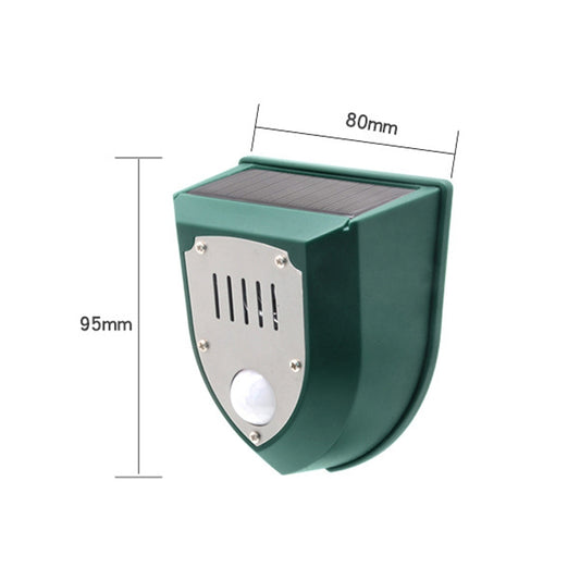 Solar animal alarm lamp side view, green shield housing with top solar panel