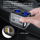 Ozio dual-USB car charger inserted in socket with hand, switches, and two blue ports