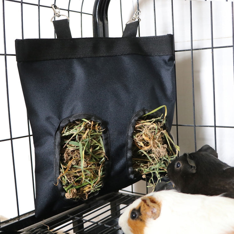 Black hanging hay storage bag attached to a wire cage with four hay pocket openings