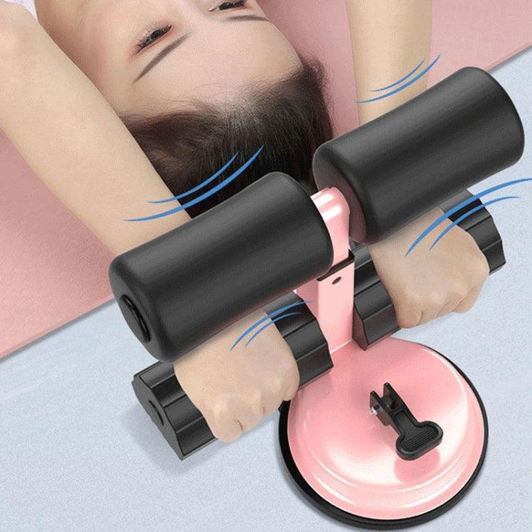 Sit-up aid exercise device in use with black rollers and pink suction cup base