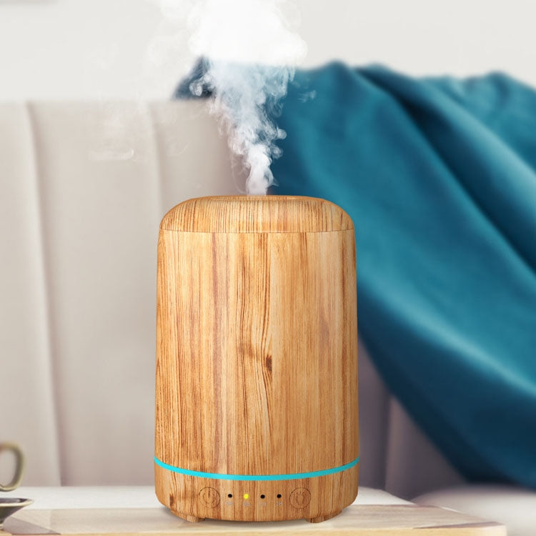 Light wood-grain aromatherapy air purifier emitting steam, rounded cylinder with teal accent band