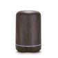 Dark wood-grain aromatherapy air purifier, rounded cylinder with teal base ring and control icons