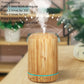 Light wood-grain aromatherapy air purifier with steam rising, rounded cylinder and teal accent band