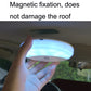 Handheld magnetic dome LED car light showing blue glow under car roof