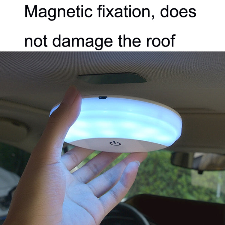 Handheld magnetic dome LED car light showing blue glow under car roof