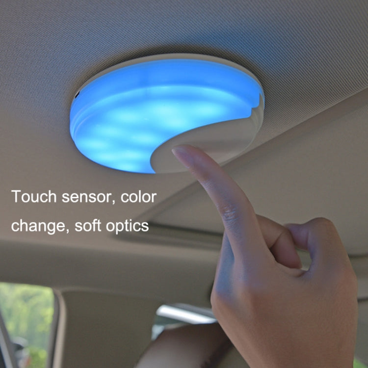 Touch-activated dome LED car light, blue glow, white housing on ceiling