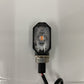 Single LED motorcycle turn signal lamp with amber lens, black octagon housing, red wire lead