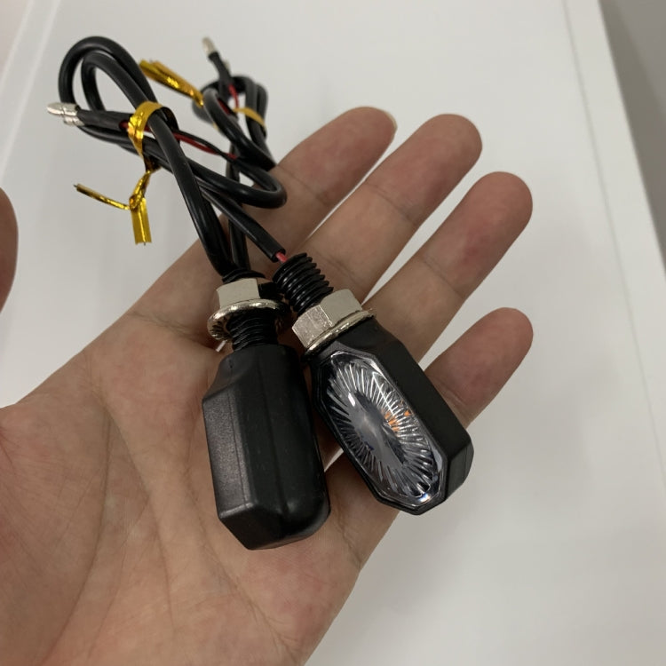 LED motorcycle turn signal lights with black housings, amber lenses, and connected wire leads
