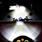 Pair of LED fog lamps projecting bright beam, round black housings