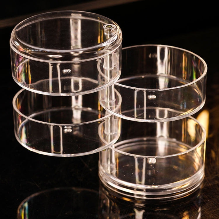 Transparent 4-tier jewelry box showing stacked clear rings and top lid