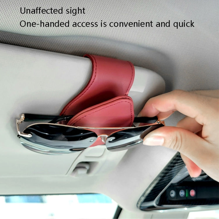 Car sun visor glasses clip storage, red pouch with glasses being clipped by hand
