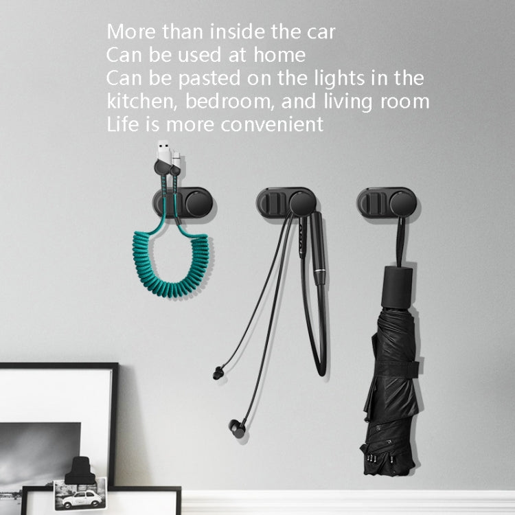 Adhesive car storage hooks holding cables, keys, and an umbrella
