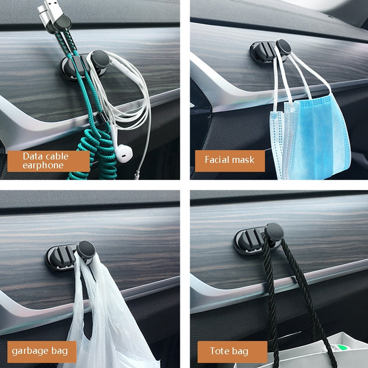 Car interior adhesive hooks with teal cords holding accessories like earphones and masks
