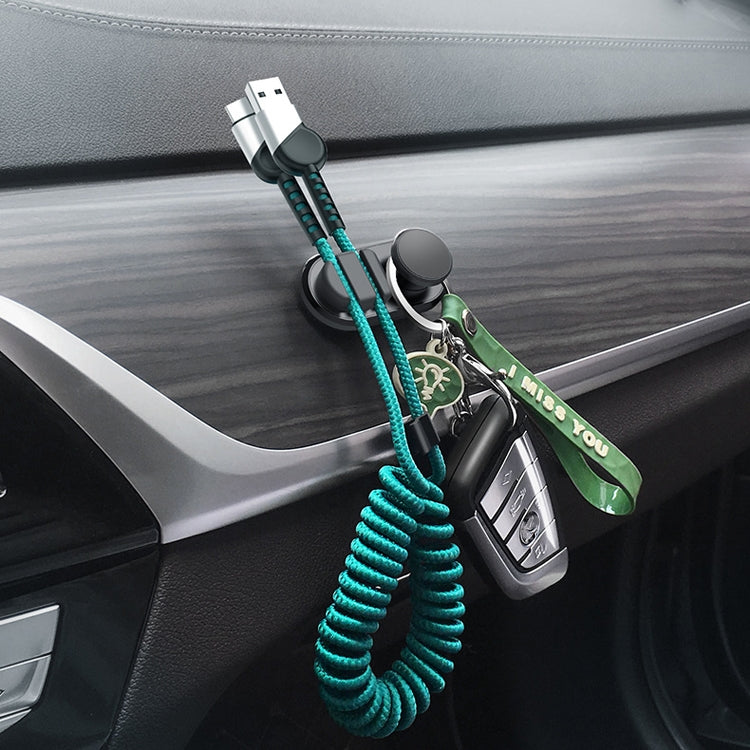 Black adhesive car hook with teal coiled lanyard and keychain on the console