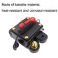 Automatic circuit breaker switch, dark casing with red rocker and gold electrical terminals
