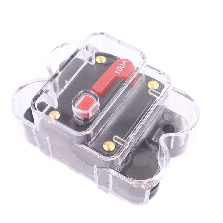 Automatic circuit breaker switch, clear housing with red 100A label and push button.