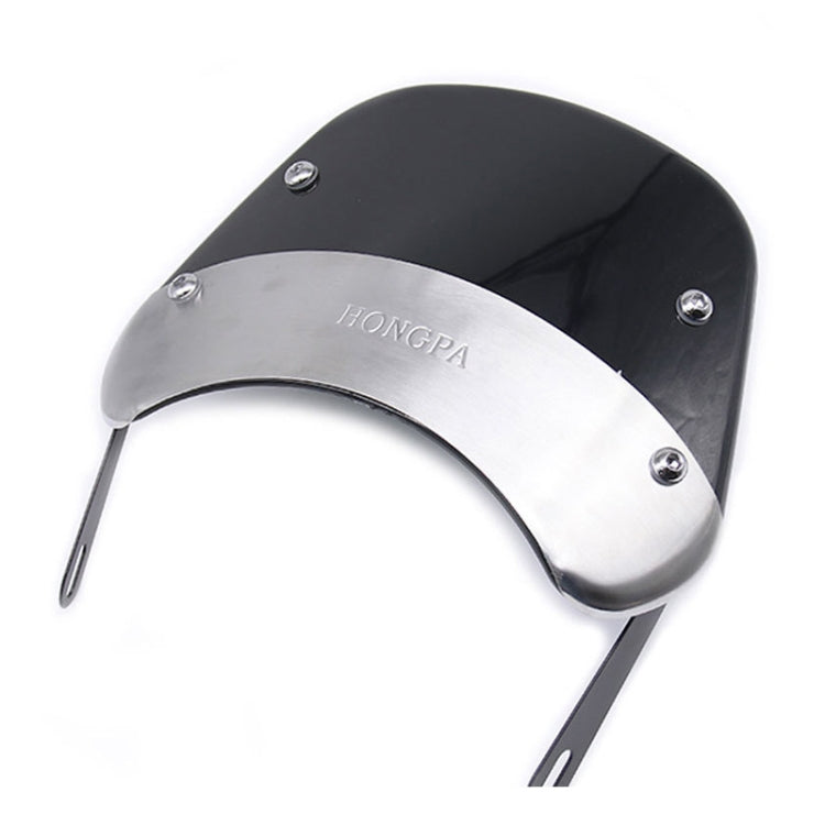 Smoked motorcycle windshield, angled view with curved visor and four mounting screws