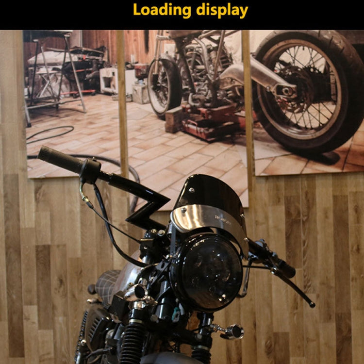 Retro motorcycle with installed smoked windshield above the headlight and handlebars