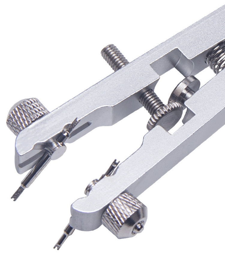 Close-up of silver V-shape watch pin removal pliers with spring-loaded arms