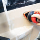 Handheld pneumatic polishing machine applying buffing pad to a leather surface