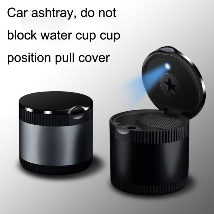 Black car ashtray with LED ambient light, open top with blue star glow on lid.