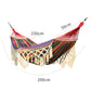Double canvas hammock with multicolor stripes, cream macrame net, and red end ropes.