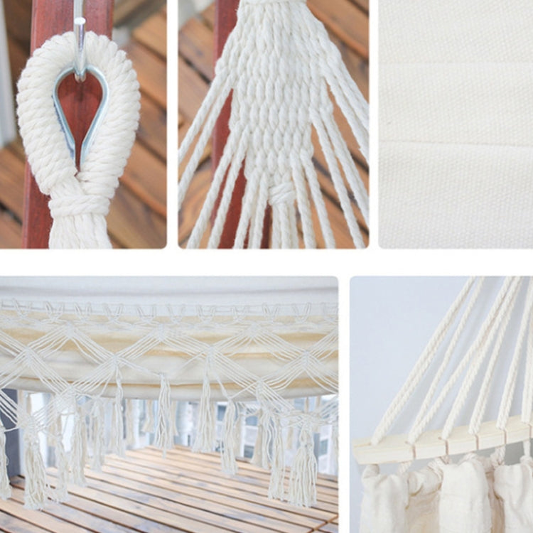 White hammock close-up with braided end ropes and dense fringe tassels.