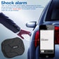 Black GPS tracker device with rugged top and metal logo, shown beside a car
