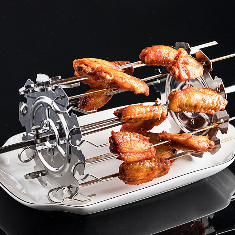 Electric skewer grill with several cooked lamb pieces on metal rods