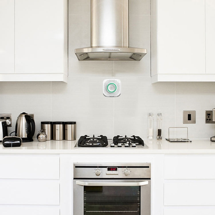 WiFi gas leak detector on wall, white unit with green alarm status ring