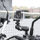 Action camera mounted on black handlebar clamp with flexible mounting arm