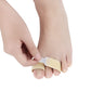 Beige elastic toe belt finger splitter held on toes by an elastic band