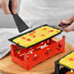Mini cheese grill with black tray, red base, and black wooden handle