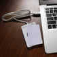 Contactless IC card reader with connected white USB cable