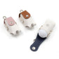 Three leather mini golf protective bags in light gray, pink, brown, and blue with carabiners