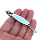 Silver fishing lure with blue oval sequin body and treble hooks, held in hand