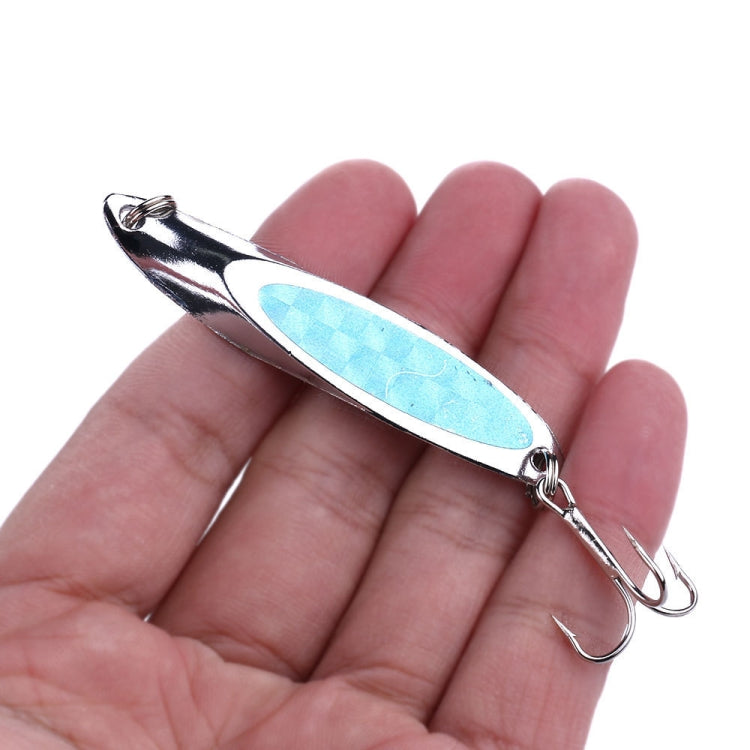 Silver fishing lure with blue oval sequin body and treble hooks, held in hand