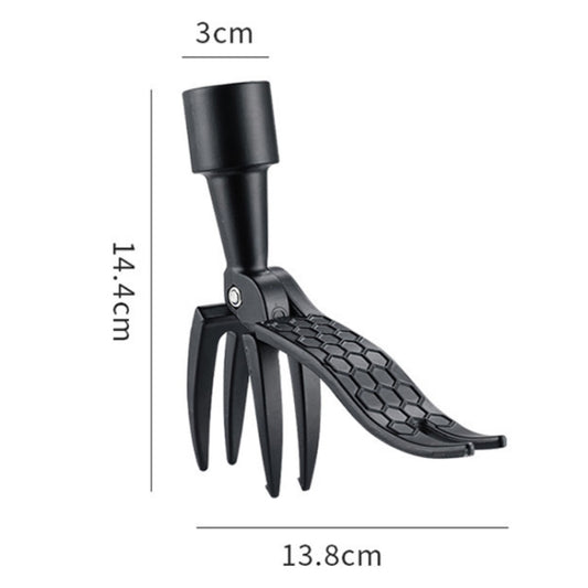 Black weeding tool with barbed fork tines and hex-patterned head for precision weeding