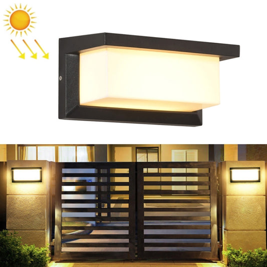 Black wall-mounted solar wall light with rectangular frosted diffuser and warm glow