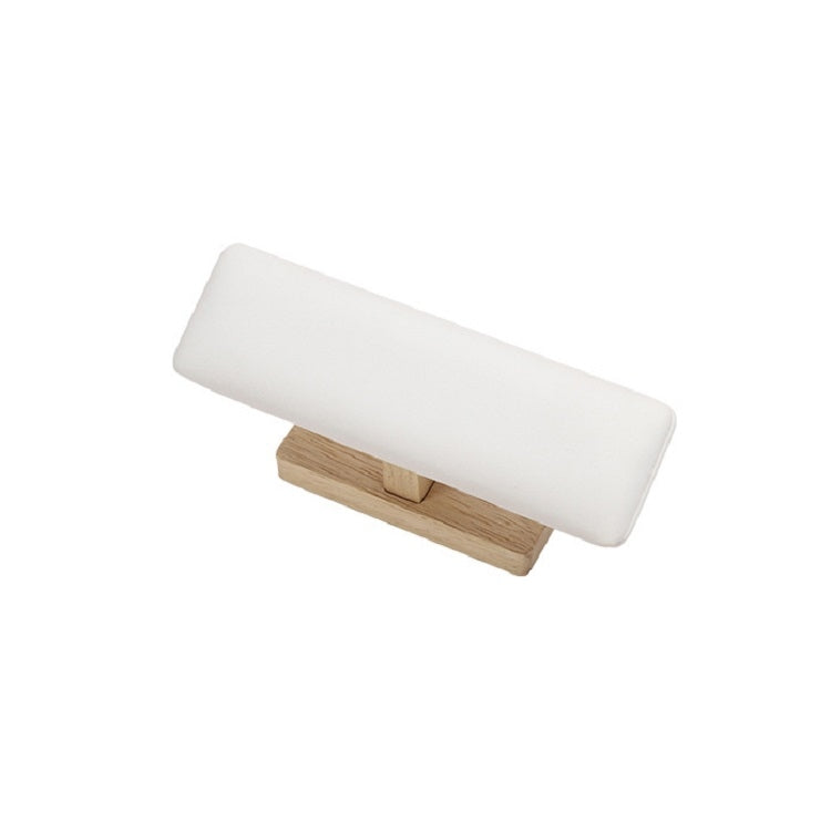 T-shaped jewelry display stand with white padded bar and light wood base, side view