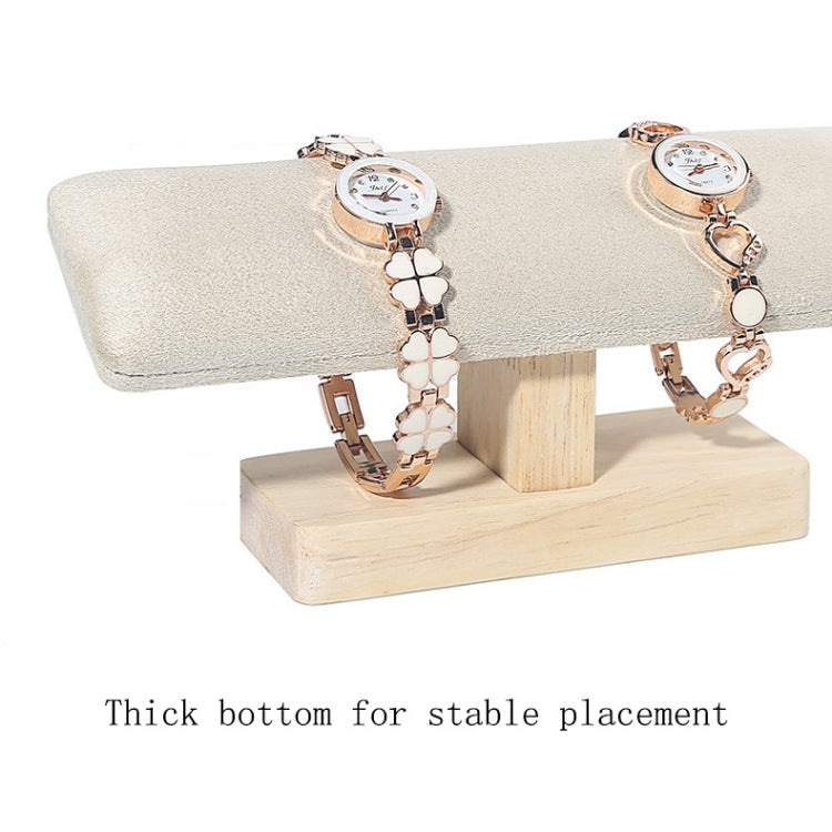 T-shaped jewelry display stand with beige fabric padded bar and light wood base, for watches