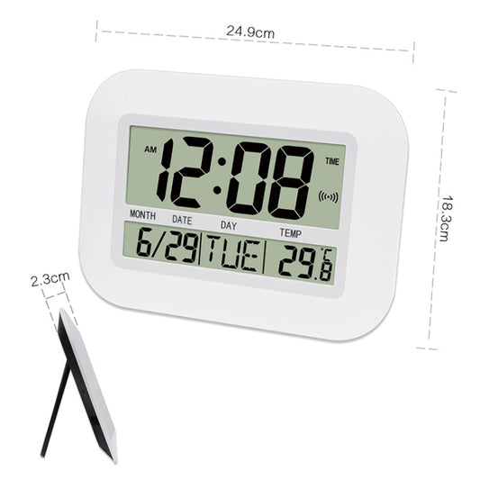 Digital alarm clock display in white housing, showing time, date, day, and temperature
