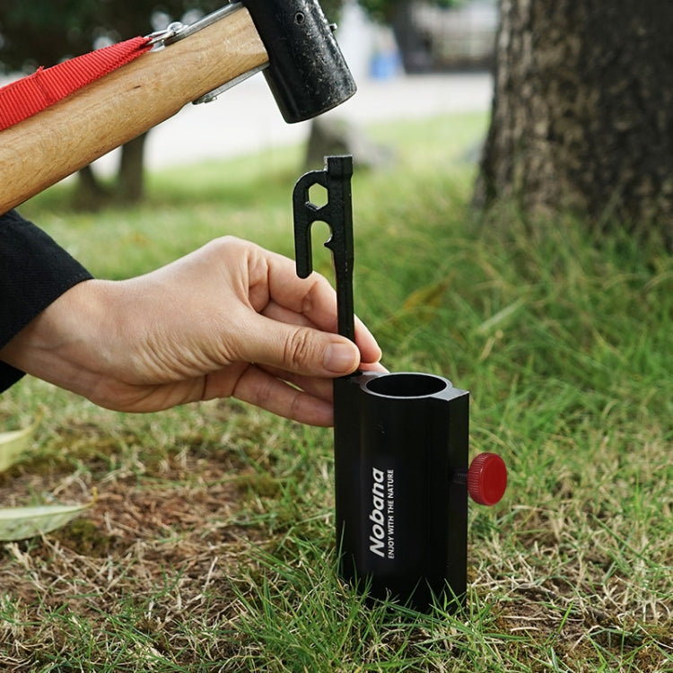 Black canopy pole holder staked on grass with red adjustment knob and support bar