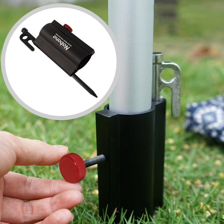 Black canopy pole holder on grass with hands adjusting red knob on threaded rod