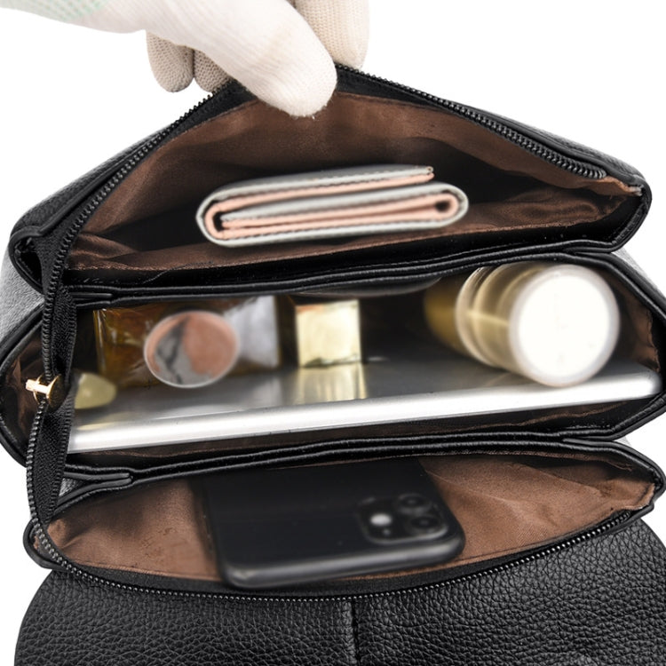 Black messenger bag open to show interior slots and zipper pocket