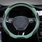 Leather steering wheel cover, black with teal outer trim and contrast stitching, front view